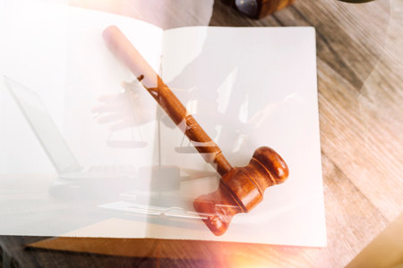 Justice and law concept.Male judge in a courtroom with the gavel, working with, computer and docking...