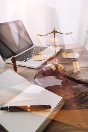 Business and lawyers discussing contract papers with brass scale on desk in office. Law, legal...
