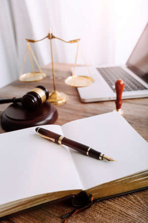 Justice and law concept.Male judge in a courtroom with the gavel, working with, computer and docking...