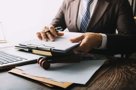 Business and lawyers discussing contract papers with brass scale on desk in office. Law, legal...