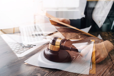 Business and lawyers discussing contract papers with brass scale on desk in office. Law, legal...