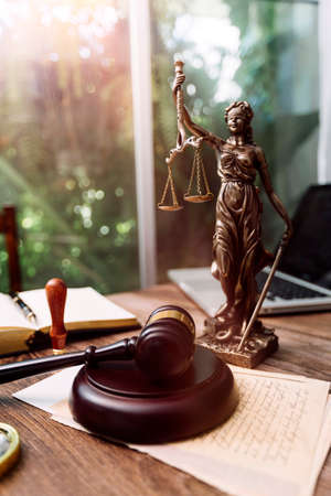 Business and lawyers discussing contract papers with brass scale on desk in office. Law, legal...