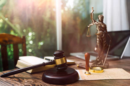 Justice and law concept.Male judge in a courtroom with the gavel, working with, computer and docking...