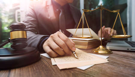 Business and lawyers discussing contract papers with brass scale on desk in office. Law, legal...
