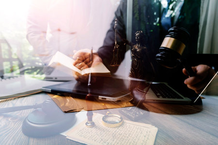 Business and lawyers discussing contract papers with brass scale on desk in office. Law, legal...