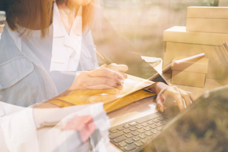 Portrait of Starting small businesses SME owners, two Asian woman check online orders Selling...