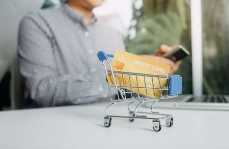 technology, people and online shopping concept - happy smiling man with tablet pc computer and...