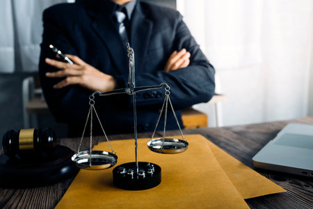 Business and lawyers discussing contract papers with brass scale on desk in office. Law, legal...