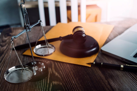 Business and lawyers discussing contract papers with brass scale on desk in office. Law, legal...