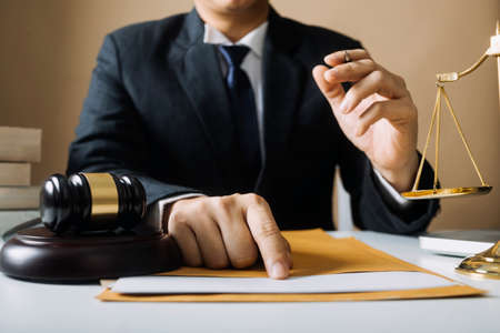 Justice and law concept.Male judge in a courtroom with the gavel, working with, computer and docking...