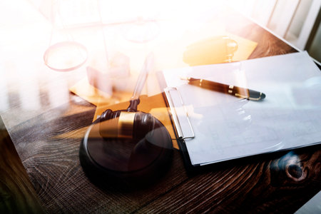 Business and lawyers discussing contract papers with brass scale on desk in office. Law, legal...