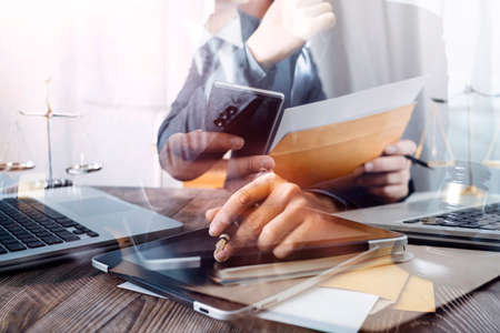 Business and lawyers discussing contract papers with brass scale on desk in office. Law, legal...