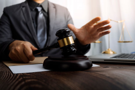 Justice and law concept.Male judge in a courtroom with the gavel, working with, computer and docking...