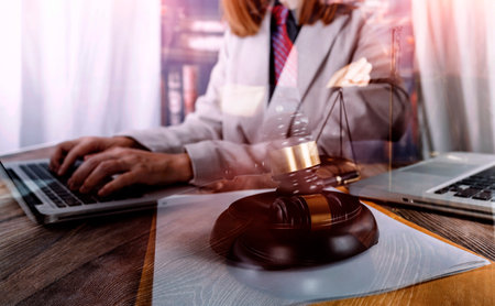 Business and lawyers discussing contract papers with brass scale on desk in office. Law, legal...