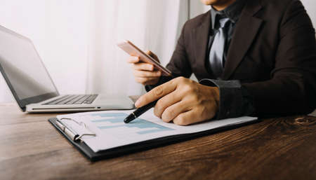Business People Meeting to analyse and discuss and brainstorming the financial report chart data in...