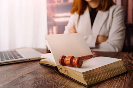 Business and lawyers discussing contract papers with brass scale on desk in office. Law, legal services, advice, justice and law concept picture with film grain effectの写真素材