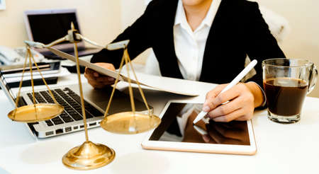 Business and lawyers discussing contract papers with brass scale on desk in office. Law, legal...
