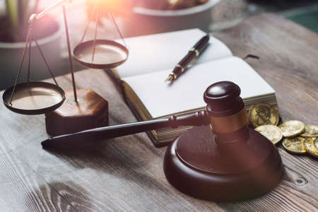 Business and lawyers discussing contract papers with brass scale on desk in office. Law, legal services, advice, justice and law concept picture with film grain effectの写真素材