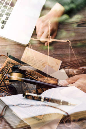 justice and law concept.Male judge in a courtroom on wooden table and Counselor or Male lawyer working in office. Legal law, advice and justice concept.の写真素材