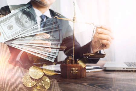 justice and law concept.Male judge in a courtroom on wooden table and Counselor or Male lawyer working in office. Legal law, advice and justice concept.の写真素材