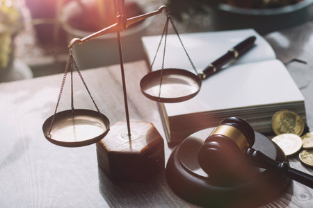 Business and lawyers discussing contract papers with brass scale on desk in office. Law, legal services, advice, justice and law concept picture with film grain effectの写真素材