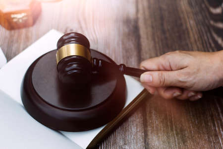 Business and lawyers discussing contract papers with brass scale on desk in office. Law, legal services, advice, justice and law concept picture with film grain effectの写真素材