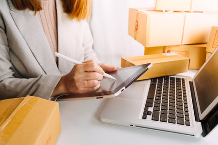 Online sales ideas for work at home. Asian man is answering phone calls. To accept orders from online customers.Very good sale. online Business and E-commerce.Online shop Sell ââproducts at home.の写真素材