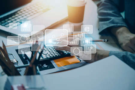 Businessman with a tablet in his hand And touching on the screen That shows a business graph. The...