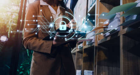 Cybersecurity and privacy concepts to protect data. Lock icon and internet network security technology. Businessman protecting personal data on smart phone with virtual screen interfaces.の写真素材