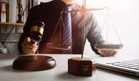 Business and lawyers discussing contract papers with brass scale on desk in office. Law, legal...