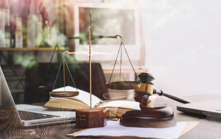 Business and lawyers discussing contract papers with brass scale on desk in office. Law, legal...