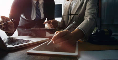 Business and lawyers discussing contract papers with brass scale on desk in office. Law, legal...