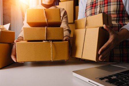 Online sales ideas for work at home. Asian man is answering phone calls. To accept orders from online customers.Very good sale. online Business and E-commerce.Online shop Sell ââproducts at home.の写真素材