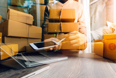Online sales ideas for work at home. Asian man is answering phone calls. To accept orders from...