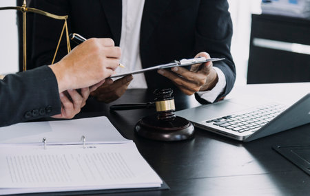 Justice and law concept. Gavel on sounding block in hand's Male judge at a courtroom, working with...