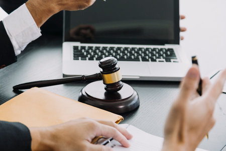 Justice and law concept. Gavel on sounding block in hand's Male judge at a courtroom, working with...