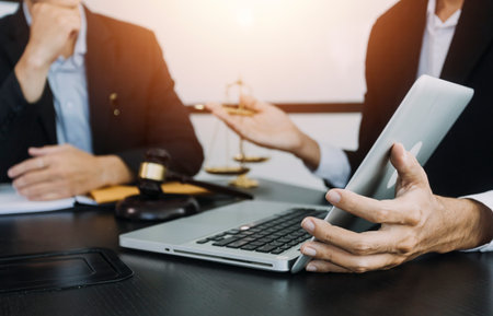 Business and lawyers discussing contract papers with brass scale on desk in office. Law, legal...