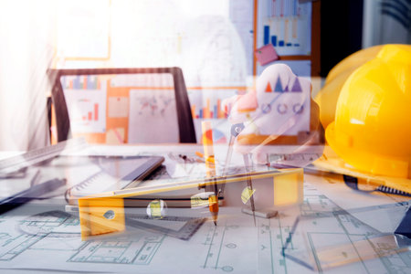 business hand working and laptop with on on architectural project at construction site at office...