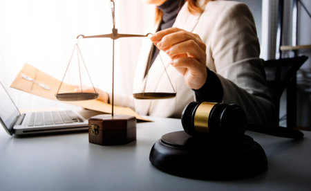 Business and lawyers discussing contract papers with brass scale on desk in office. Law, legal...