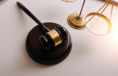 Male lawyer working with contract papers and wooden gavel on tabel in courtroom. justice and law...