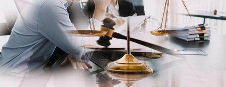 Business and lawyers discussing contract papers with brass scale on desk in office. Law, legal...