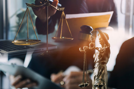 Business and lawyers discussing contract papers with brass scale on desk in office. Law, legal...