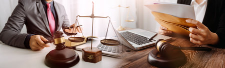 Business and lawyers discussing contract papers with brass scale on desk in office. Law, legal...