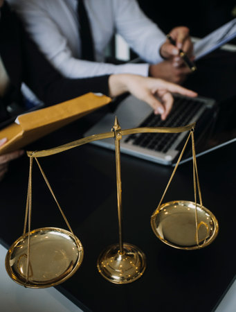 Male lawyer working with contract papers and wooden gavel on tabel in courtroom. justice and law...