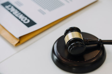 Male lawyer working with contract papers and wooden gavel on tabel in courtroom. justice and law...