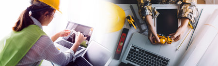 business hand working and laptop with on on architectural project at construction site at office...