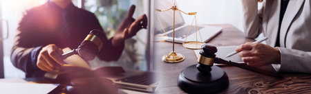 Business and lawyers discussing contract papers with brass scale on desk in office. Law, legal...