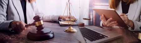 Business and lawyers discussing contract papers with brass scale on desk in office. Law, legal...