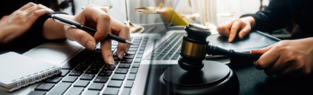 justice and law concept.Male judge in a courtroom on wooden table and Counselor or Male lawyer working in office. Legal law, advice and justice concept.の写真素材