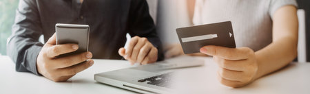 technology, people and online shopping concept - happy smiling man with tablet pc computer and credit card at homeの写真素材